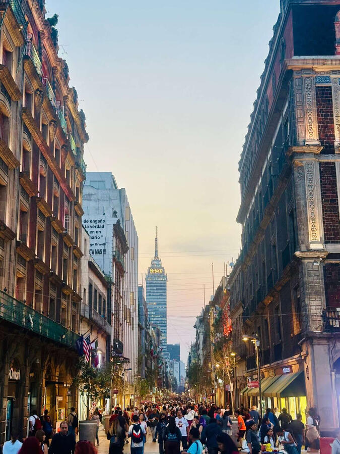 View of Madero Street pedestrian street in Mexico City's historic center with a view of the Torre Latinoamericana, captured during a walking tour.