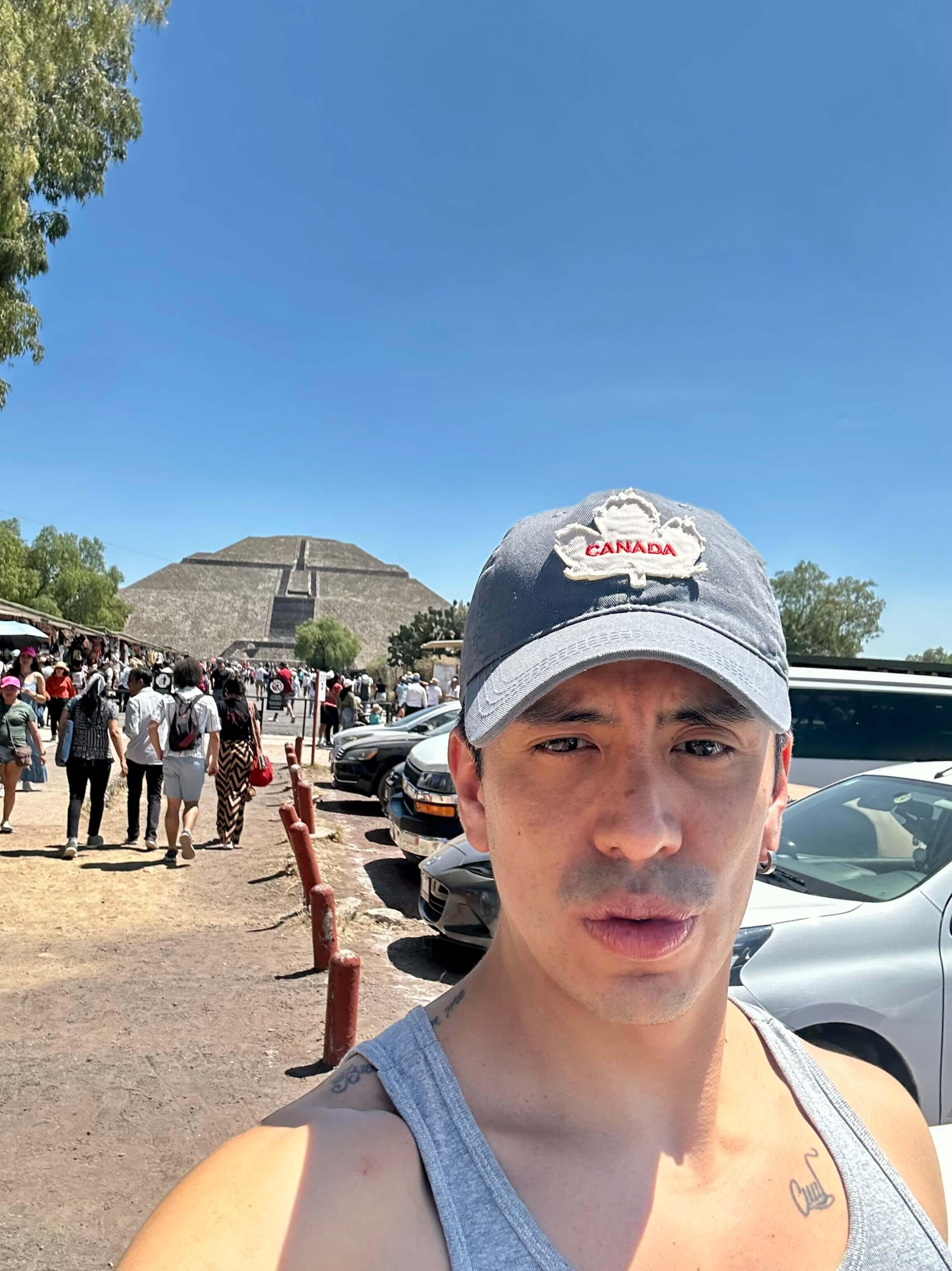 Erik, Your Private Mexico City Guide A warm selfie of Erik, your private guide, posing with the massive Pyramid of the Sun in Teotihuacan, highlighting the personalized connection of our exclusive cultural tours near Mexico City.