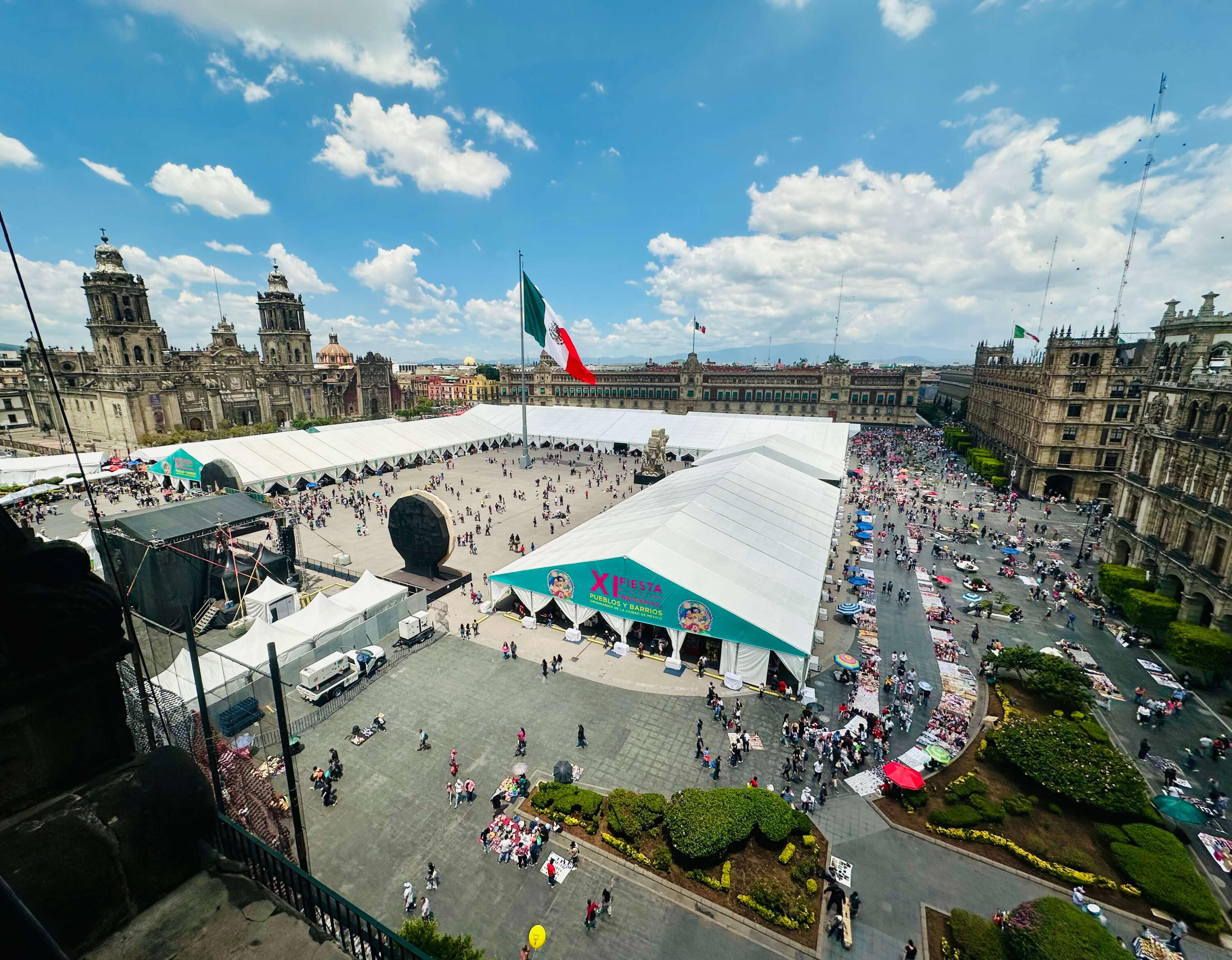 Aerial View of the Zocalo: The Heart of Mexico City Panoramic aerial view of Mexico City's Zocalo square, featuring the Metropolitan Cathedral and the XI Fiesta de las Culturas, highlighting the vibrant atmosphere of our cultural walking tours.